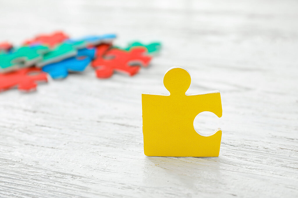 Color puzzle on wooden background